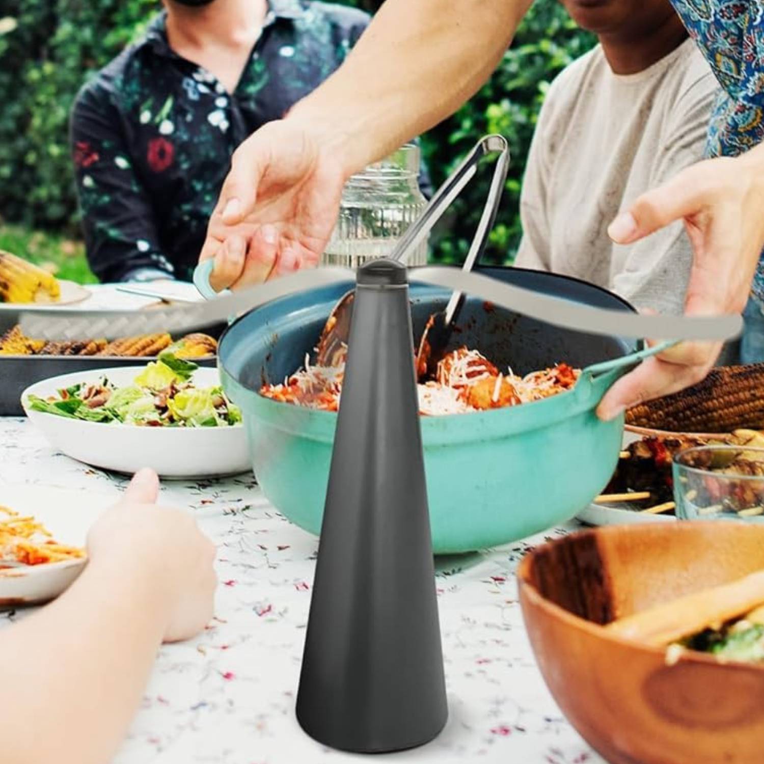 A table fly fan running beside food outdoors